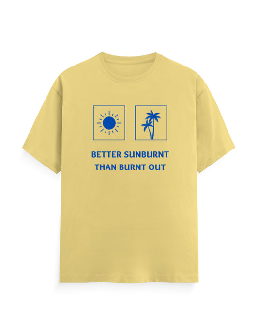 A pale yellow short-sleeve crewneck t-shirt with a blue graphic print on the front. The graphic features a sun icon in a square, a palm tree icon in a square, and the text 'BETTER SUNBURNT THAN BURNT OUT' underneath.