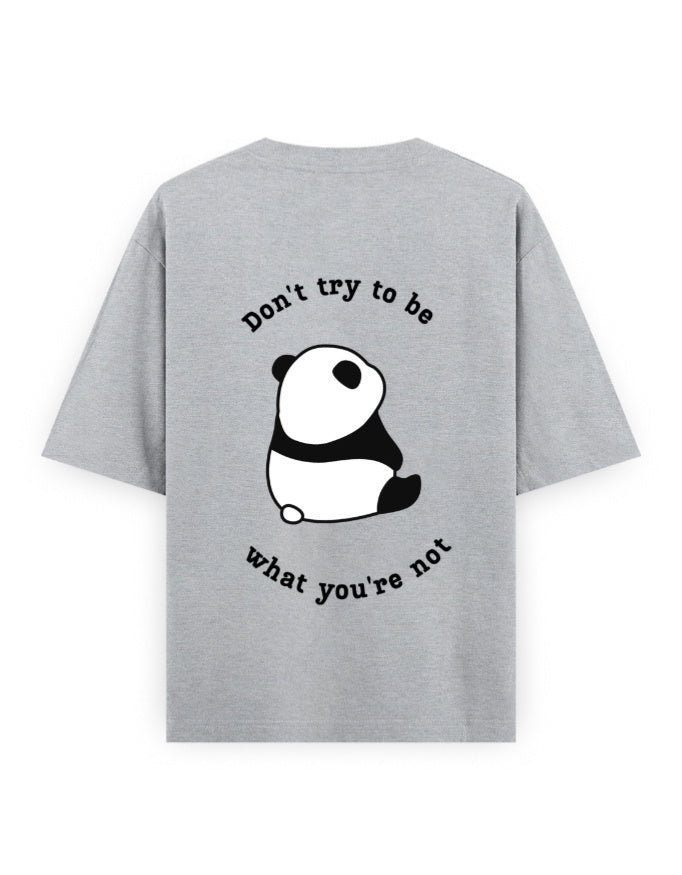Grey oversized t-shirt with panda graphic and quote stating Don’t try to be what you’re not