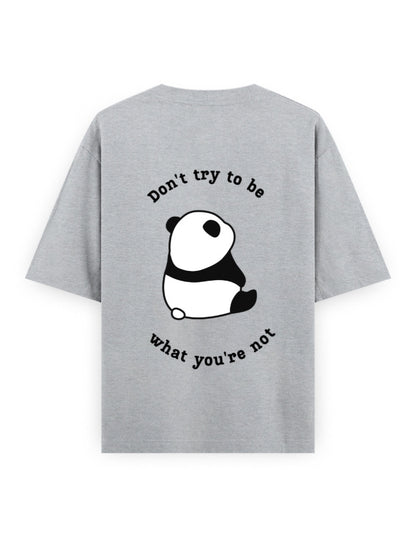 Grey oversized t-shirt with panda graphic and quote stating Don’t try to be what you’re not