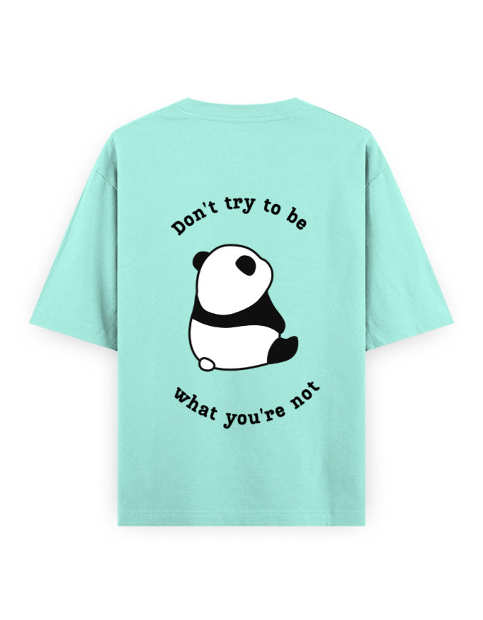 Mint color oversized t-shirt with panda graphic and quote stating Don’t try to be what you’re not