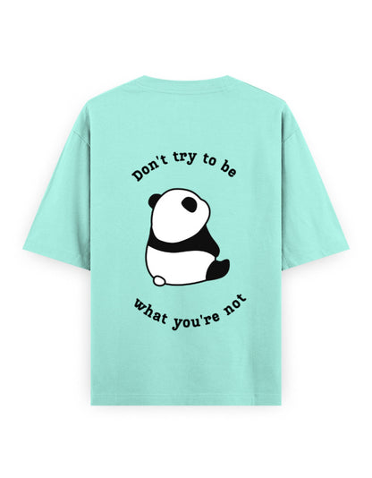 Mint color oversized t-shirt with panda graphic and quote stating Don’t try to be what you’re not