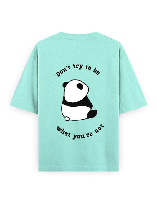 Mint color oversized t-shirt with panda graphic and quote stating Don’t try to be what you’re not