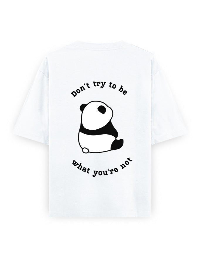 White oversized t-shirt with panda graphic and quote stating Don’t try to be what you’re not