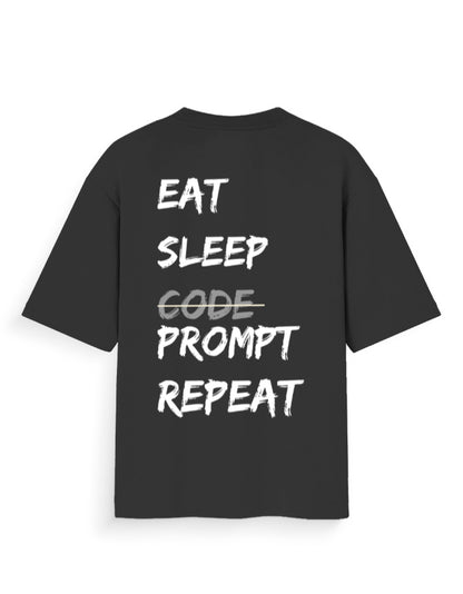 Black oversized t-shirt with AI Dev humour quote stating 'EAT SLEEP PROMPT REPEAT'