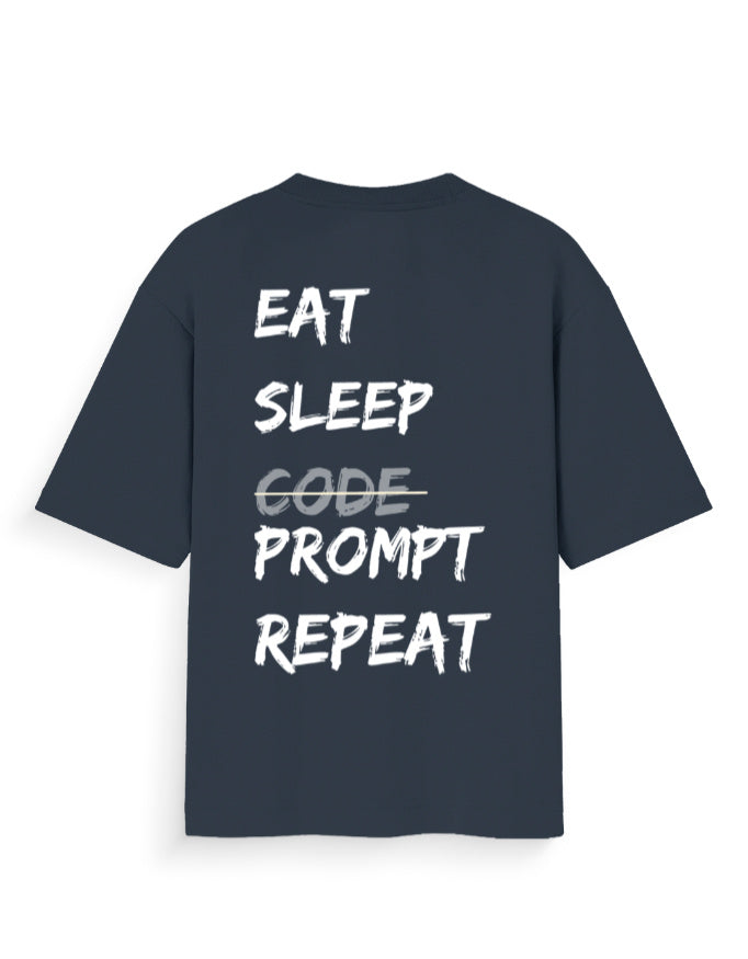 Navy blue oversized t-shirt with AI Dev humour quote stating 'EAT SLEEP PROMPT REPEAT'