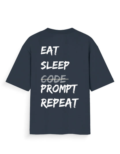 Navy blue oversized t-shirt with AI Dev humour quote stating 'EAT SLEEP PROMPT REPEAT'