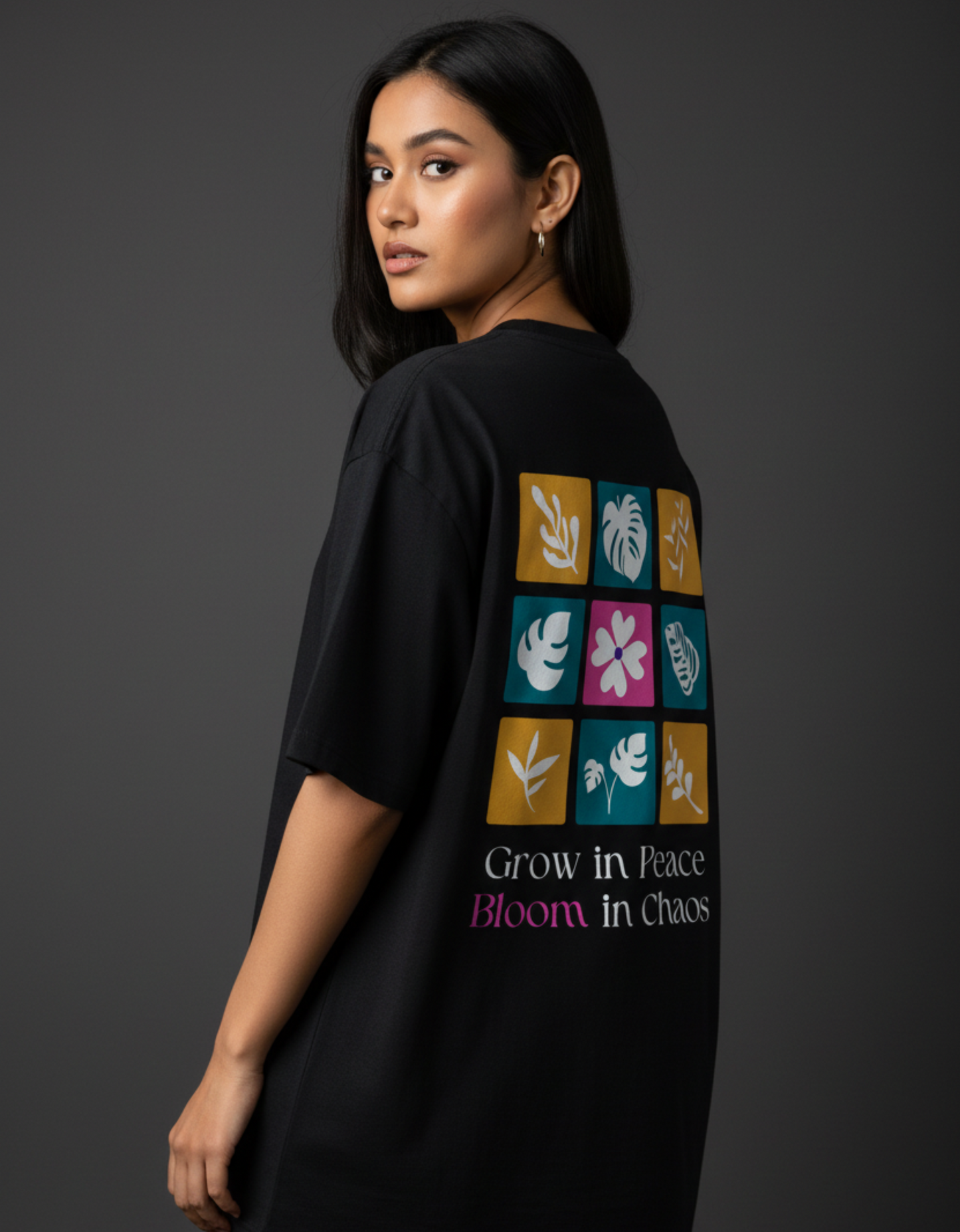 Model wearing grow in peace bloom in chaos floral black oversized t-shirt