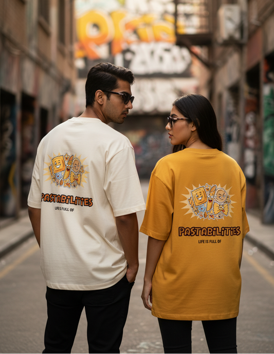 Two people standing in an alleyway wearing a humorous graphic oversized t-shirt stating Life is full of pastabilities