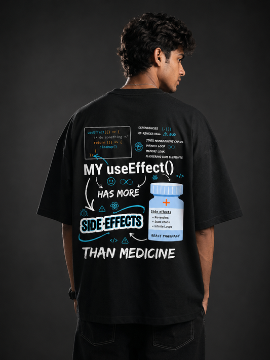 Developer wearing React limited edition black oversized tee with back print stating My useEffect() has more side effects than medicine
