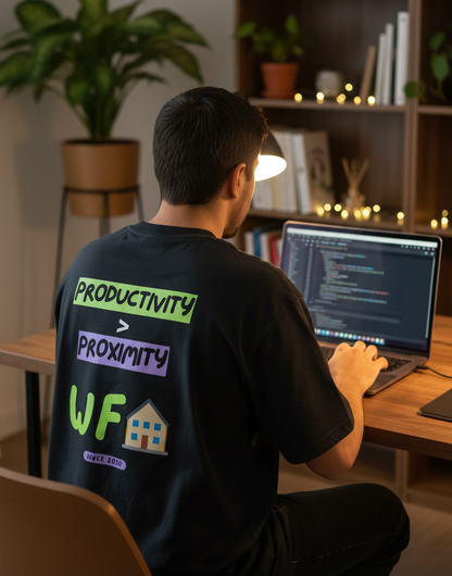 A developer working from home in a remote job and showing his tee which says productivity > proximity
